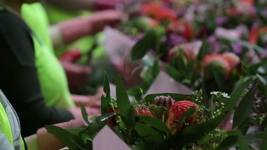 Bouquets of flowers are prepared at the Lynch Group warehouse in Sydney.