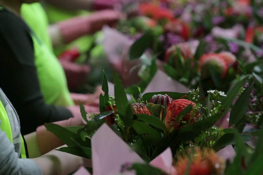 Bouquets of flowers are prepared at the Lynch Group warehouse in Sydney.