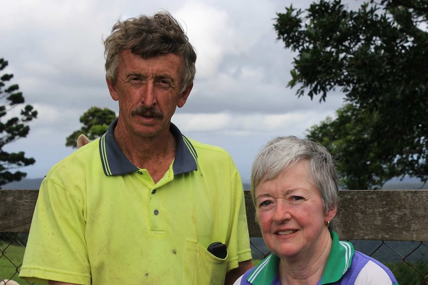 Close up of man wearing yellow shirt and woman with grey hair