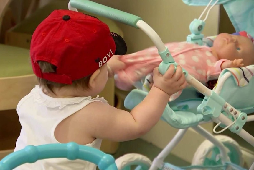 A little child wearing a red hat.