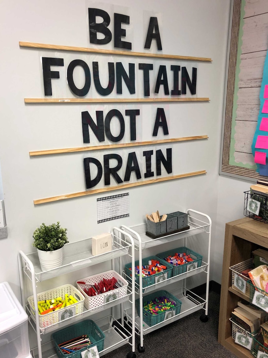 Classroom signage saying 'be a fountain, not a drain' in a story about how to establish good relationships with teachers.