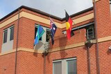 The Albury Police Station has hung an Aboriginal flag alongside the Torres Strait Islander and Australian flags.