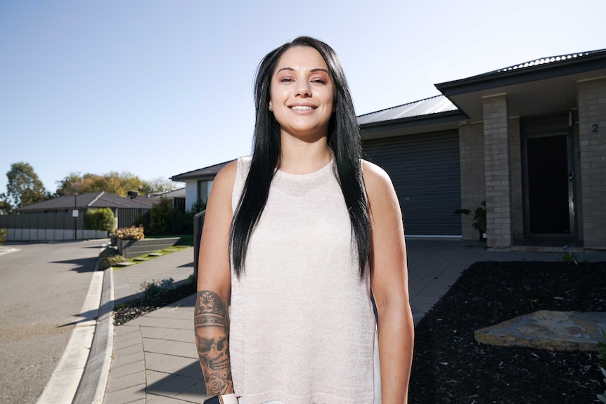 Adelaide renter Jay stands in front of a house on a sunny day