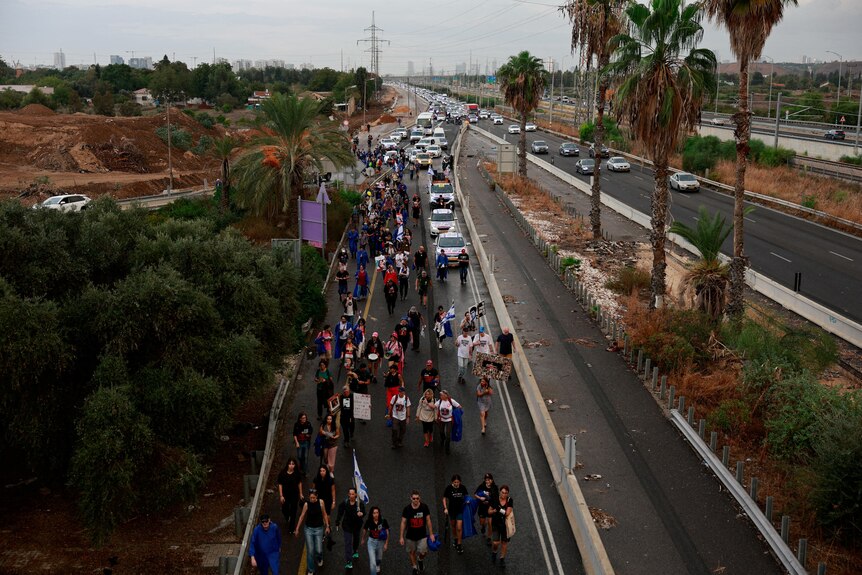 Family members march at the outskirts of Tel Aviv.