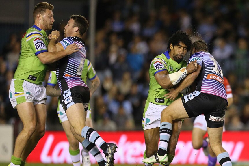 Iosia Soliola is tackled by Wade Graham