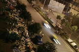 People sleep on the pavement of a street in Chengdu in Sichuan Province