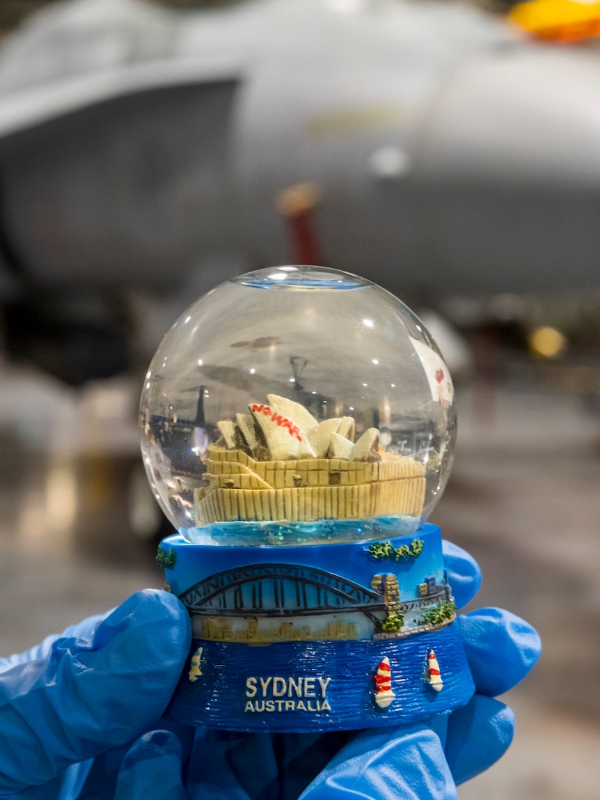 A snow globe depicting the "No War" protest graffiti on the Sydney Opera House