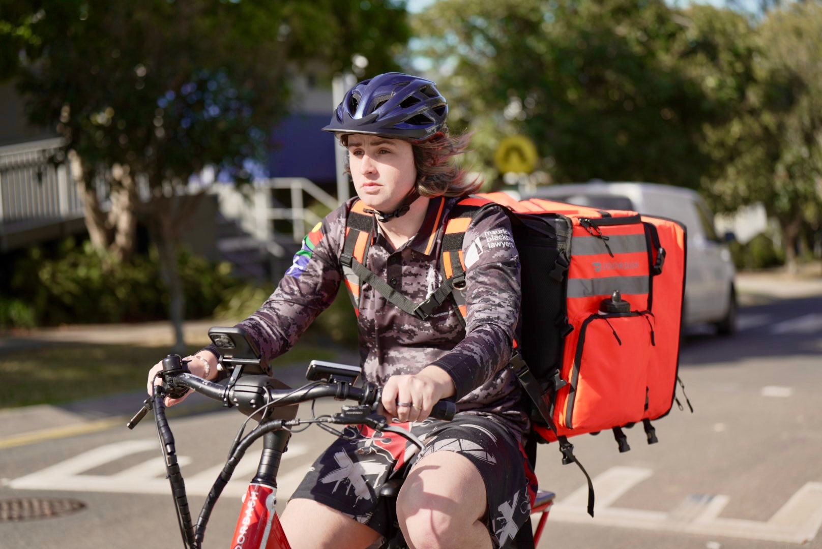 A woman rides her bike to deliver food.