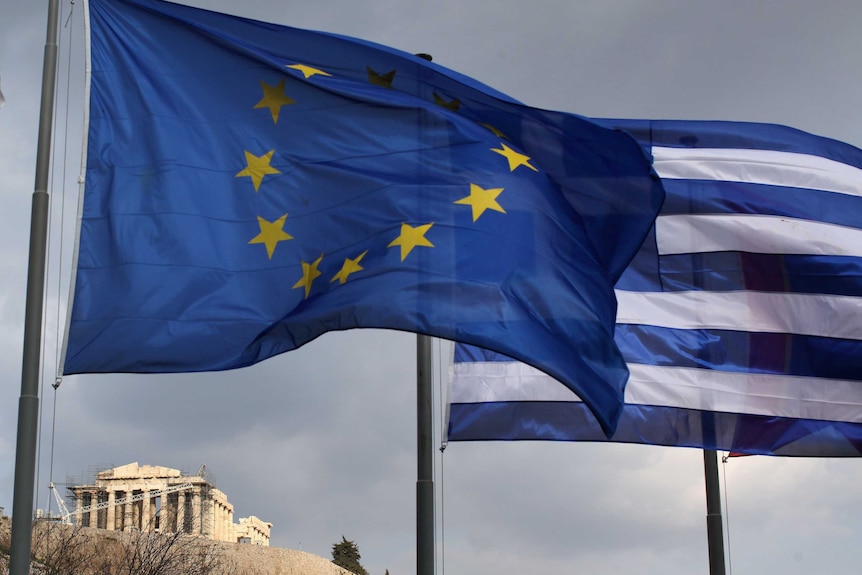 The EU and Greek flag fly in front of the Parthenon
