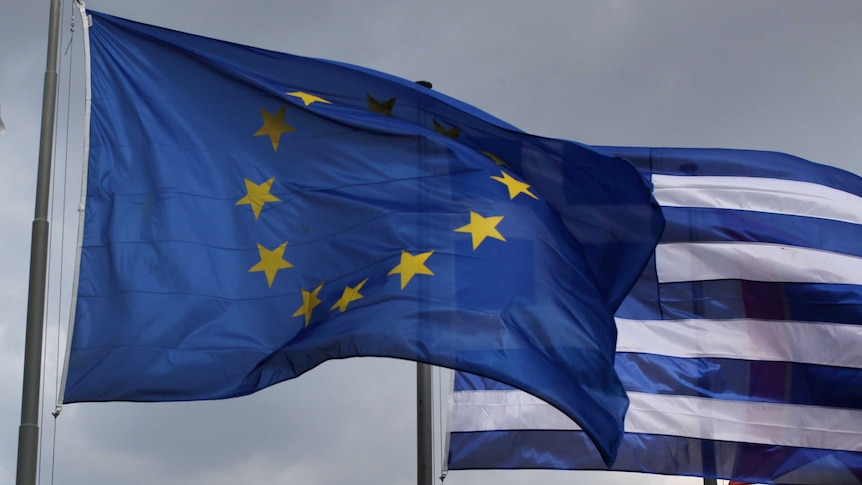 The EU and Greek flag fly in front of the Parthenon