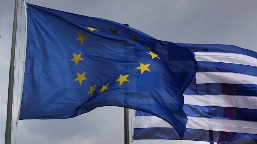 The EU and Greek flags fly in front of the Parthenon on the Acropolis