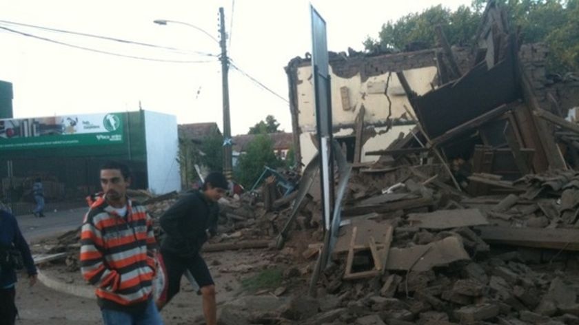 People inspect rubble in Santa Cruz, Chile