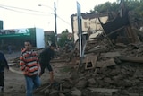 People inspect rubble in Santa Cruz, Chile