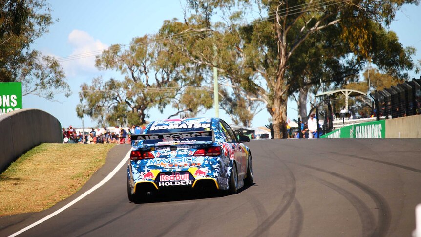 Holden car racing up a road on the Bathurst circuit.
