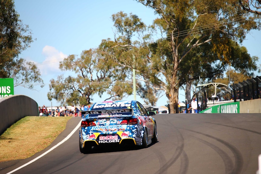 Holden car racing up a road on the Bathurst circuit.