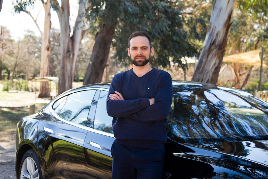 Slava Kozlovskii profile photo with Tesla.