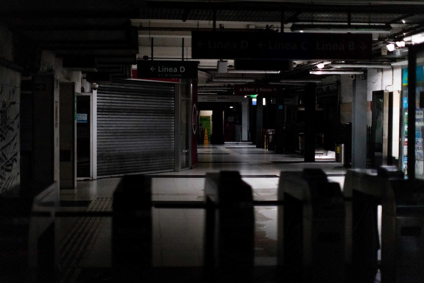 Inside a shopping centre that is extremely dark and empty