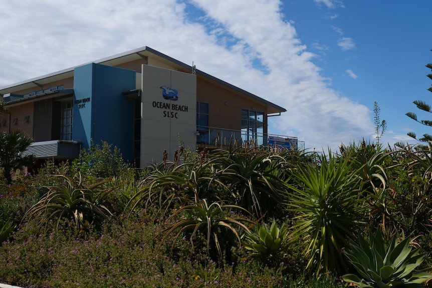 A building with a sign that reads 'Ocean Beach SLSC'