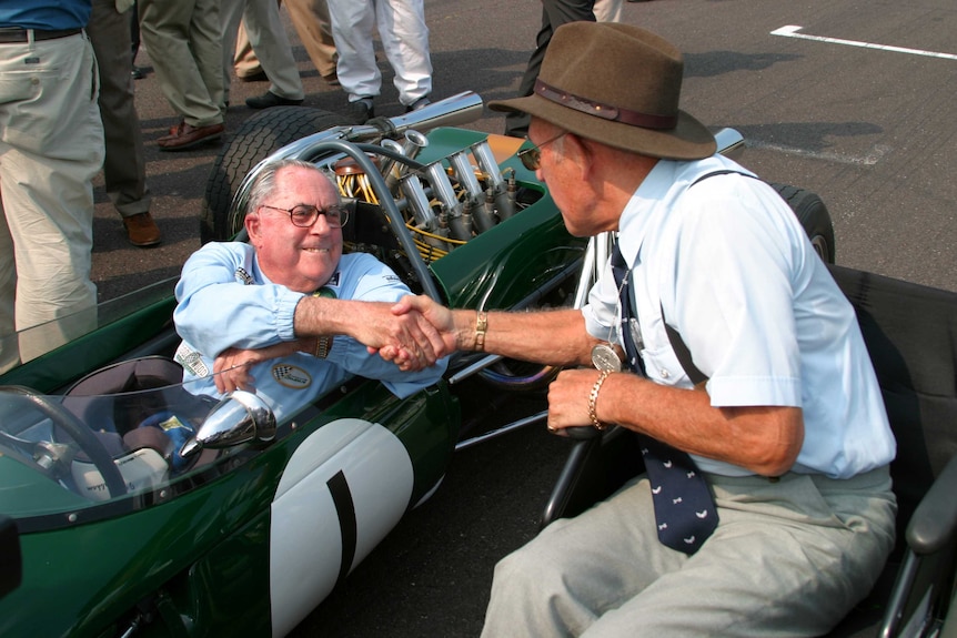 LtoR Former rivals Jack Brabham and Stirling Moss meet at the 2004 Goodwood Revival meeting.