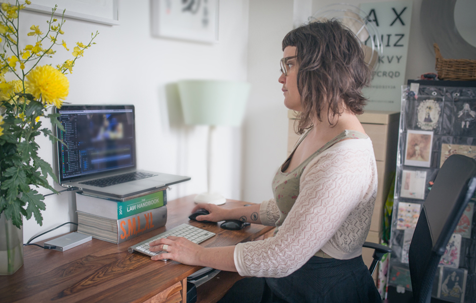 Porn film producer Gala Vanting editing video at her computer