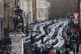 Taxi drivers block streets as they demonstrate in central London.
