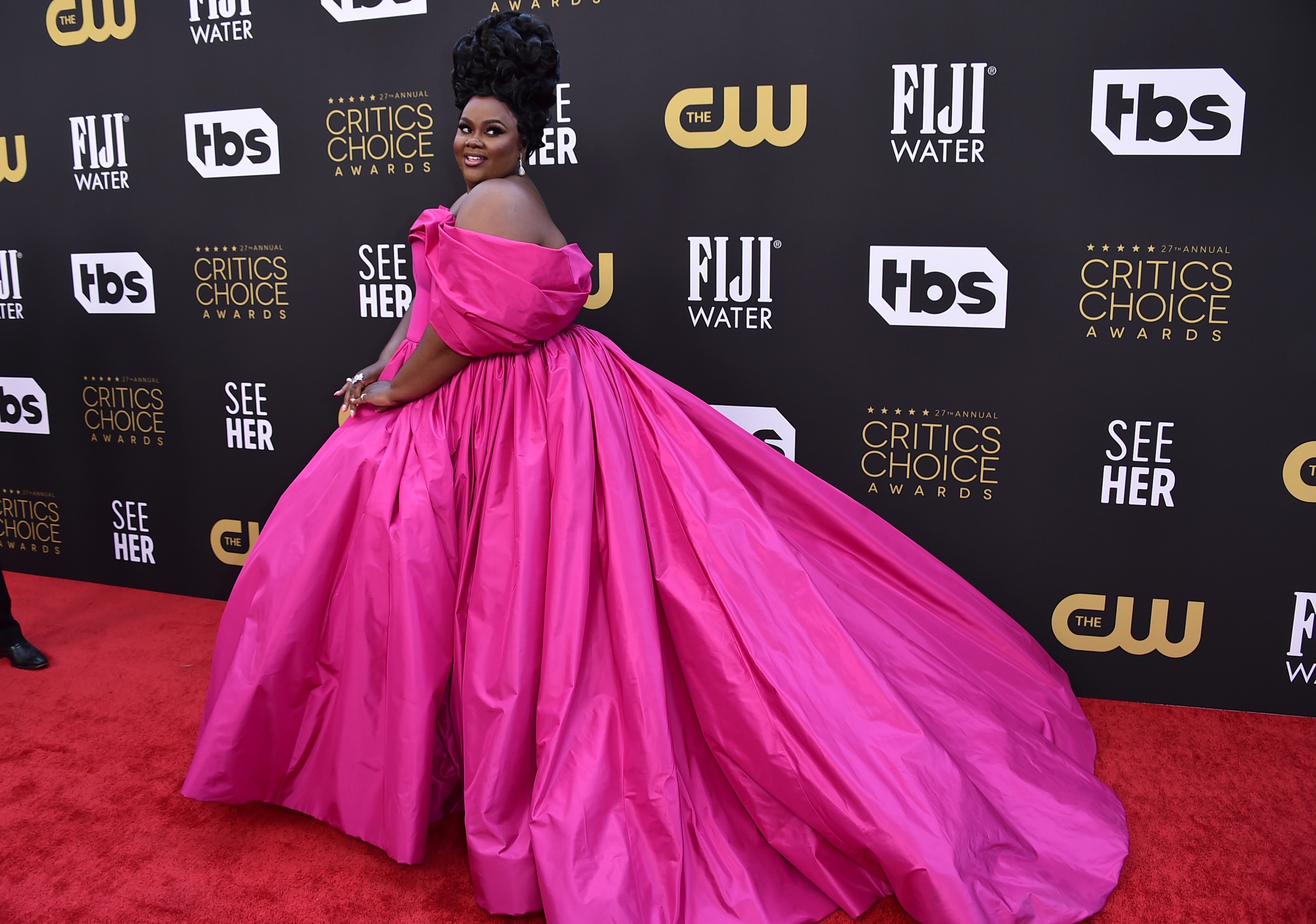 Nicole Byer poses on a red carpet at the Critics Choice Awards