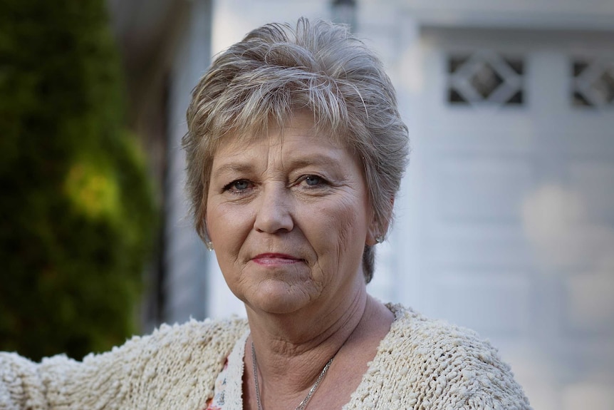 A woman with cropped grey hair