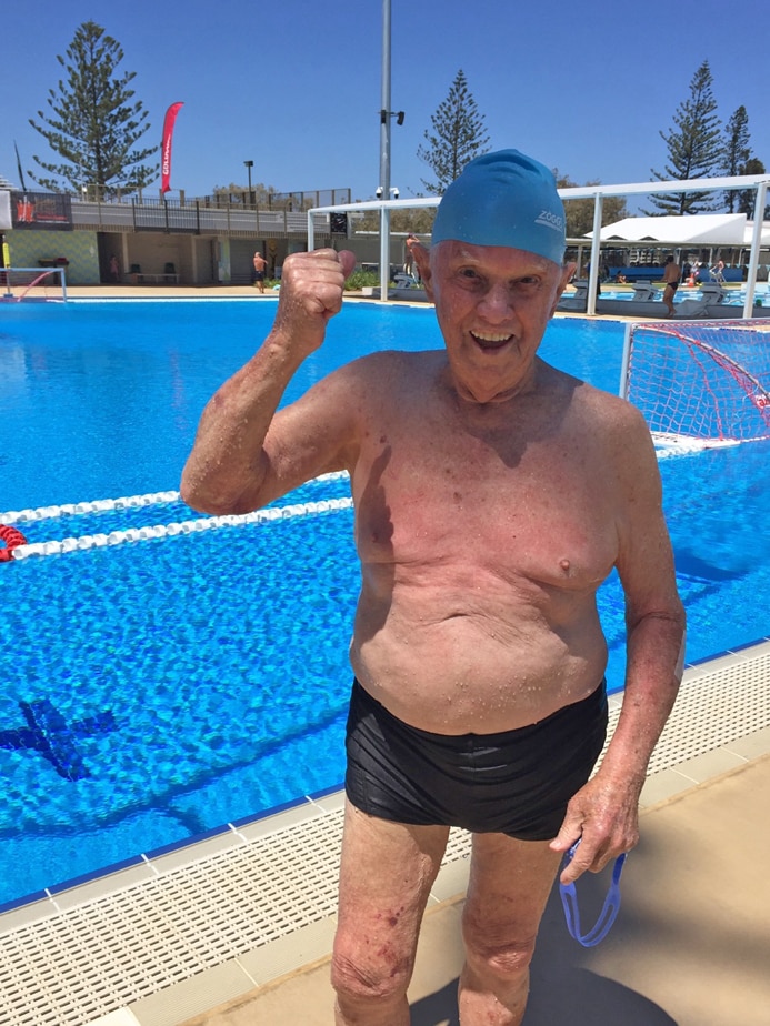 91yo competitive swimmer Don Robertson next to a pool