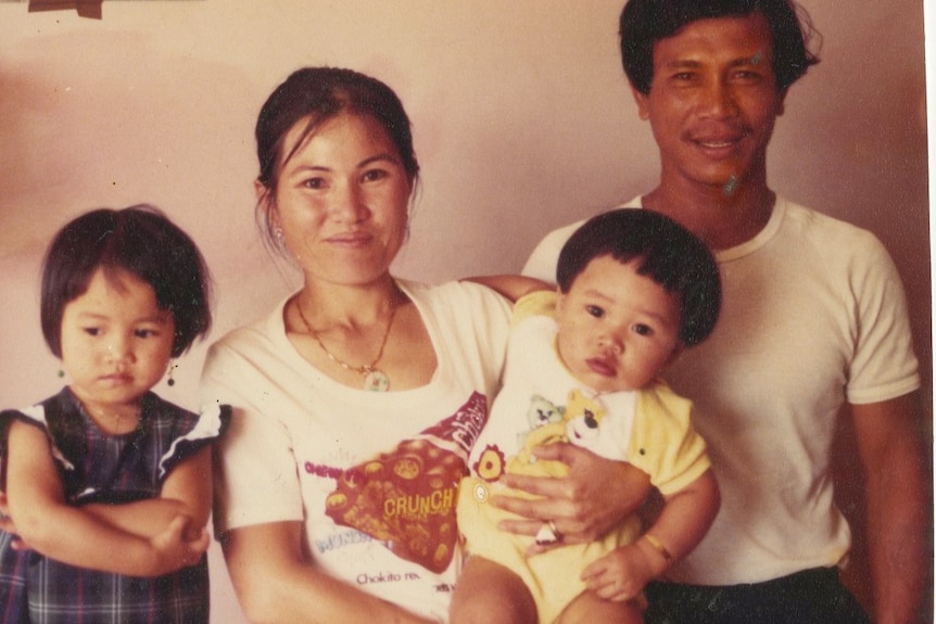 Vintage photo of young Vietnamese couple with baby boy and young girl.