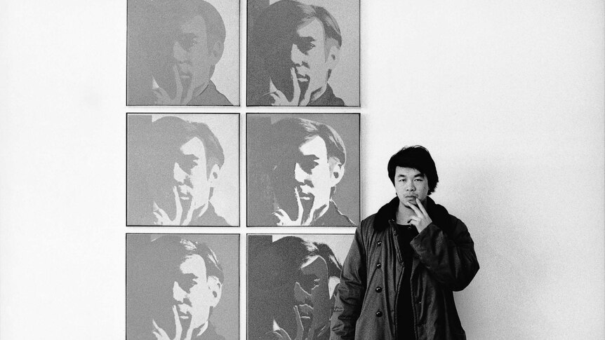 Ai Weiwei pictured with Andy Warhol's self-portraits at the Museum of Modern Art in 1987.