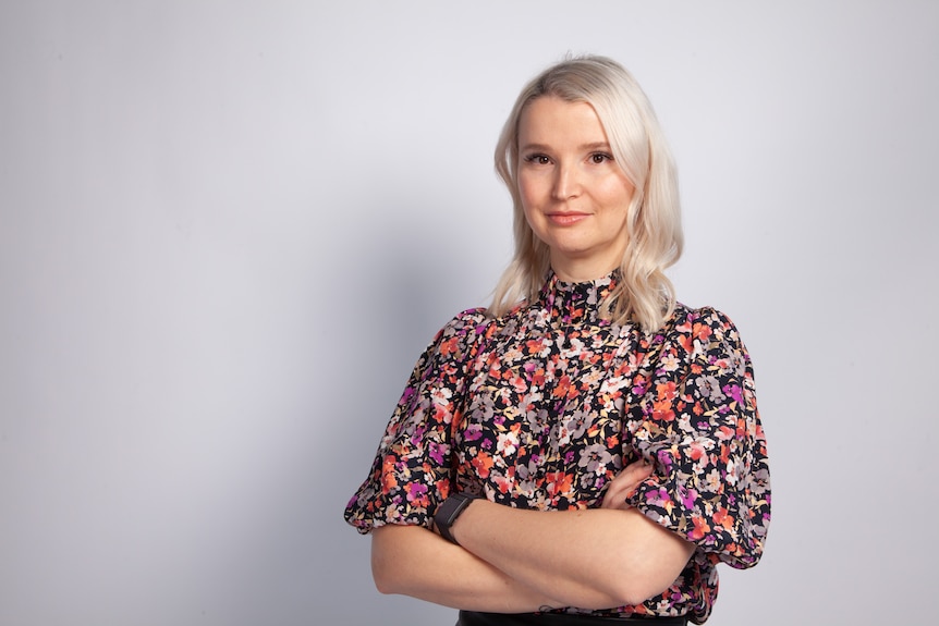 Dr Szewczyk crosses her arms and wears a floral shirt.