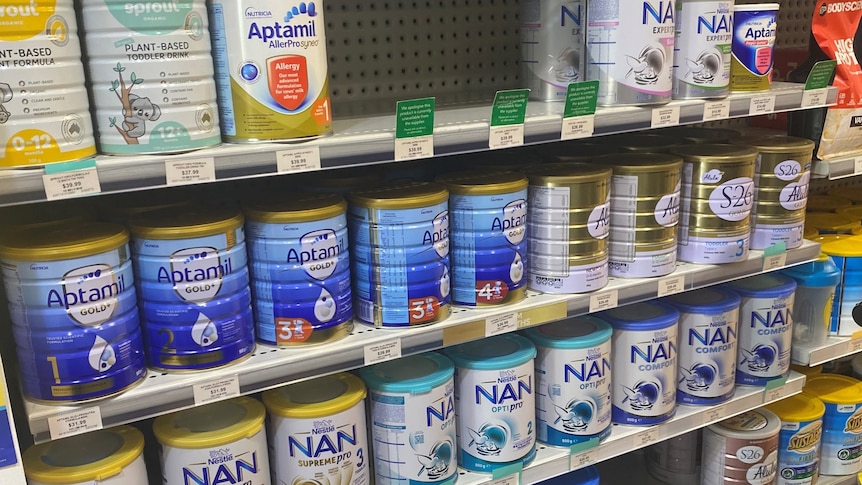 Tins of toddler and infant formula at a chemist.