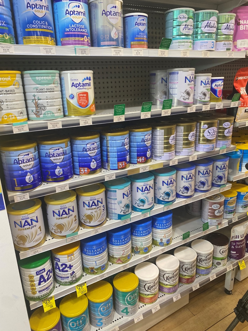 Tins of toddler and infant formula at a chemist.