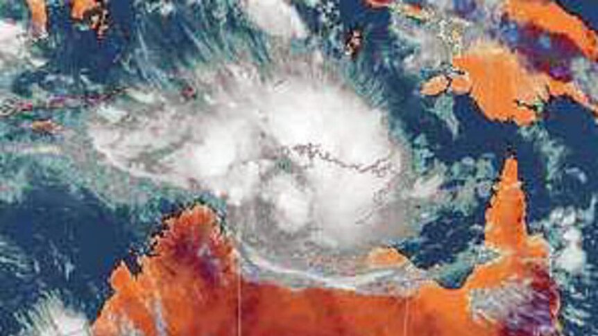 Satellite image of Australia with cyclones sitting off the coast of WA and NT