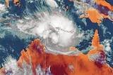 Satellite image of Australia with cyclones sitting off the coast of WA and NT