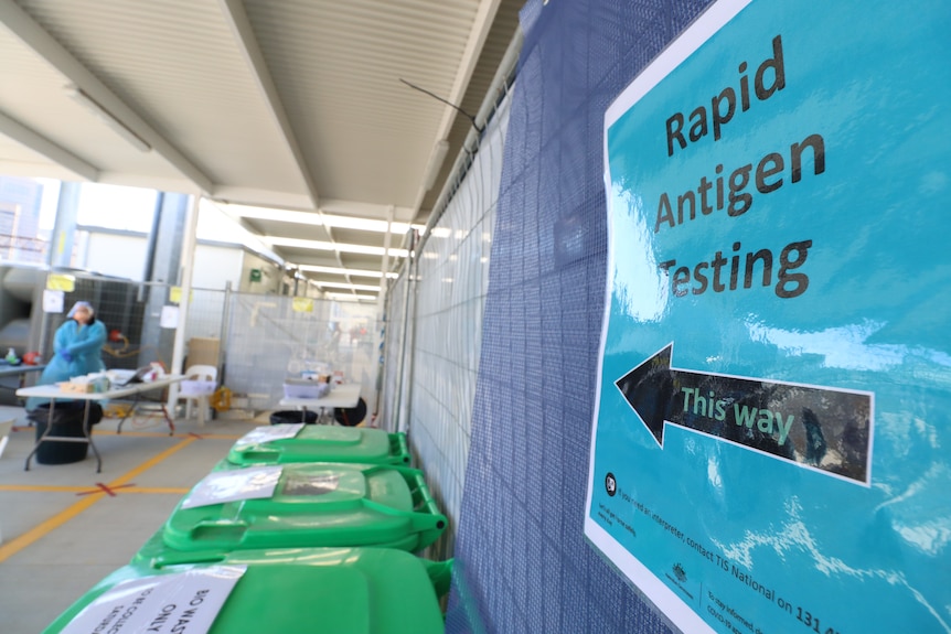 a sign saying rapid antigen testing at a building site