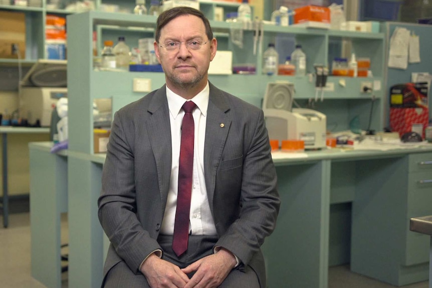 John Rasko sits in a laboratory