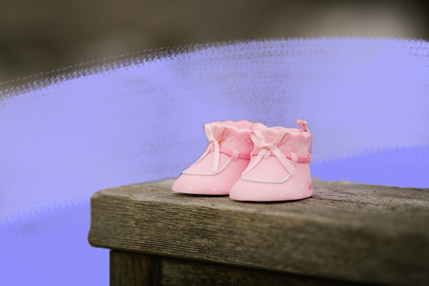 Pink baby shoes on wooden bench for a story about how to support parents of stillborn children.