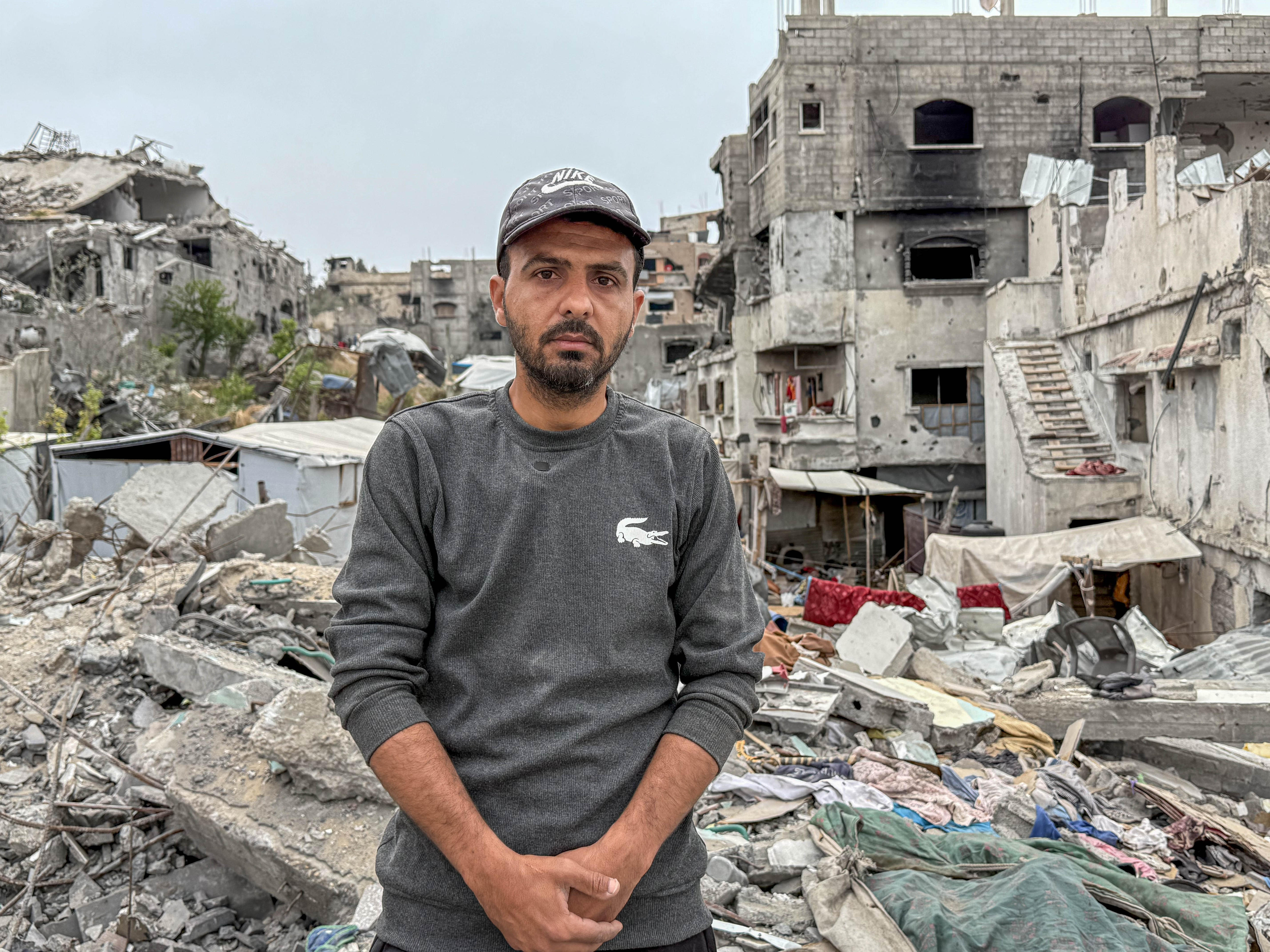 A man stands amid the rubble of his destroyed home in Gaza.