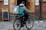 A Deliveroo worker cycles along a road in October 2017.