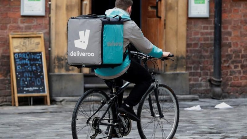 A Deliveroo worker cycles along a road in October 2017.