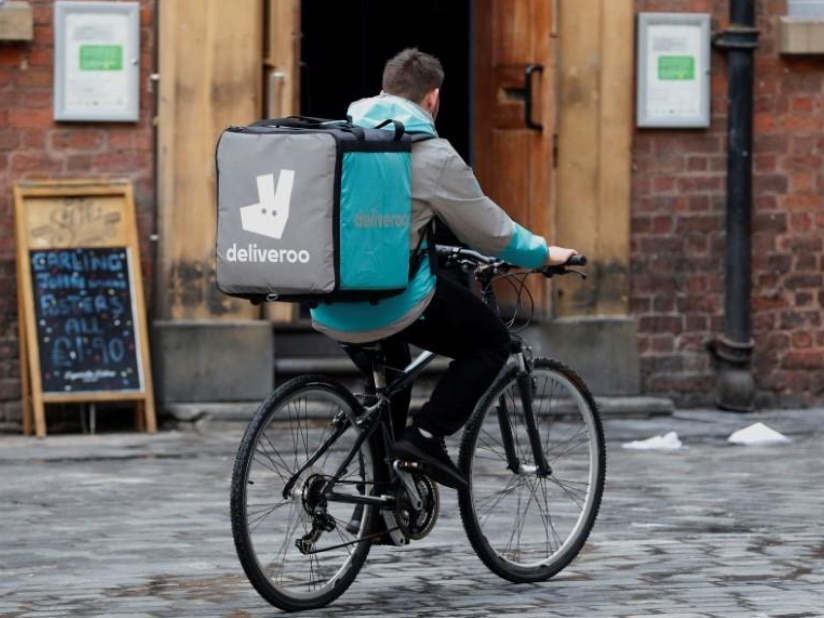 A Deliveroo worker cycles along a road in October 2017.