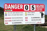 A sign warning 5 people have died at Hill 60 in the last year.