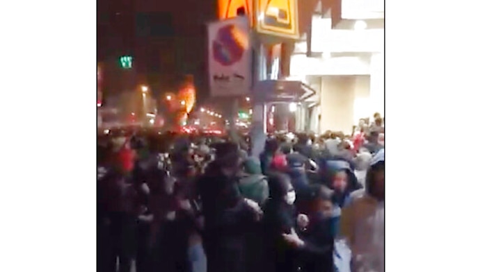 Video footage shows crowds of Iranian protesters fleeing  as police use tear gas to disperse them.