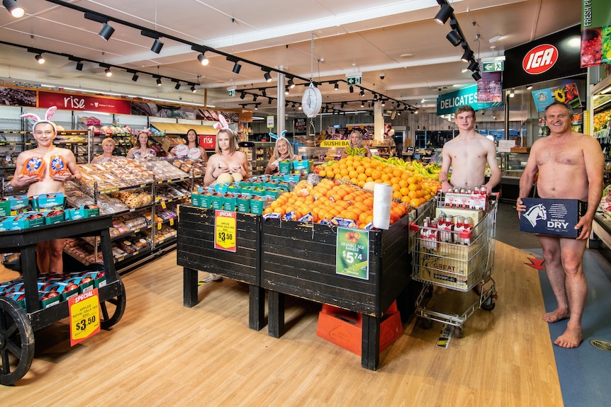 A group of people in a grocery store with strategic goods over their private parts.