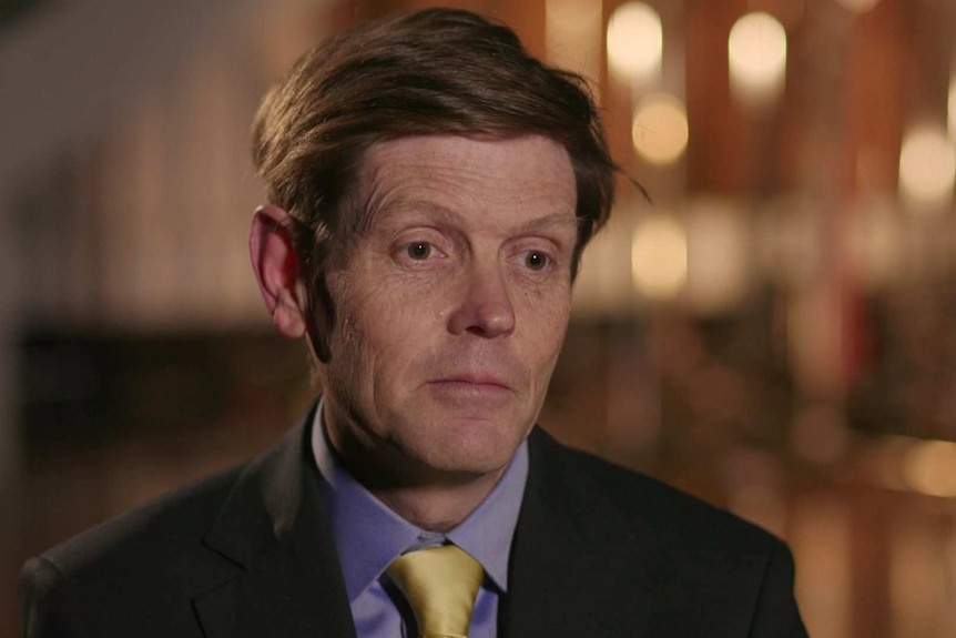 Head shot of electricity industry researcher, Bruce Mountain, sitting in front of a blurry office background