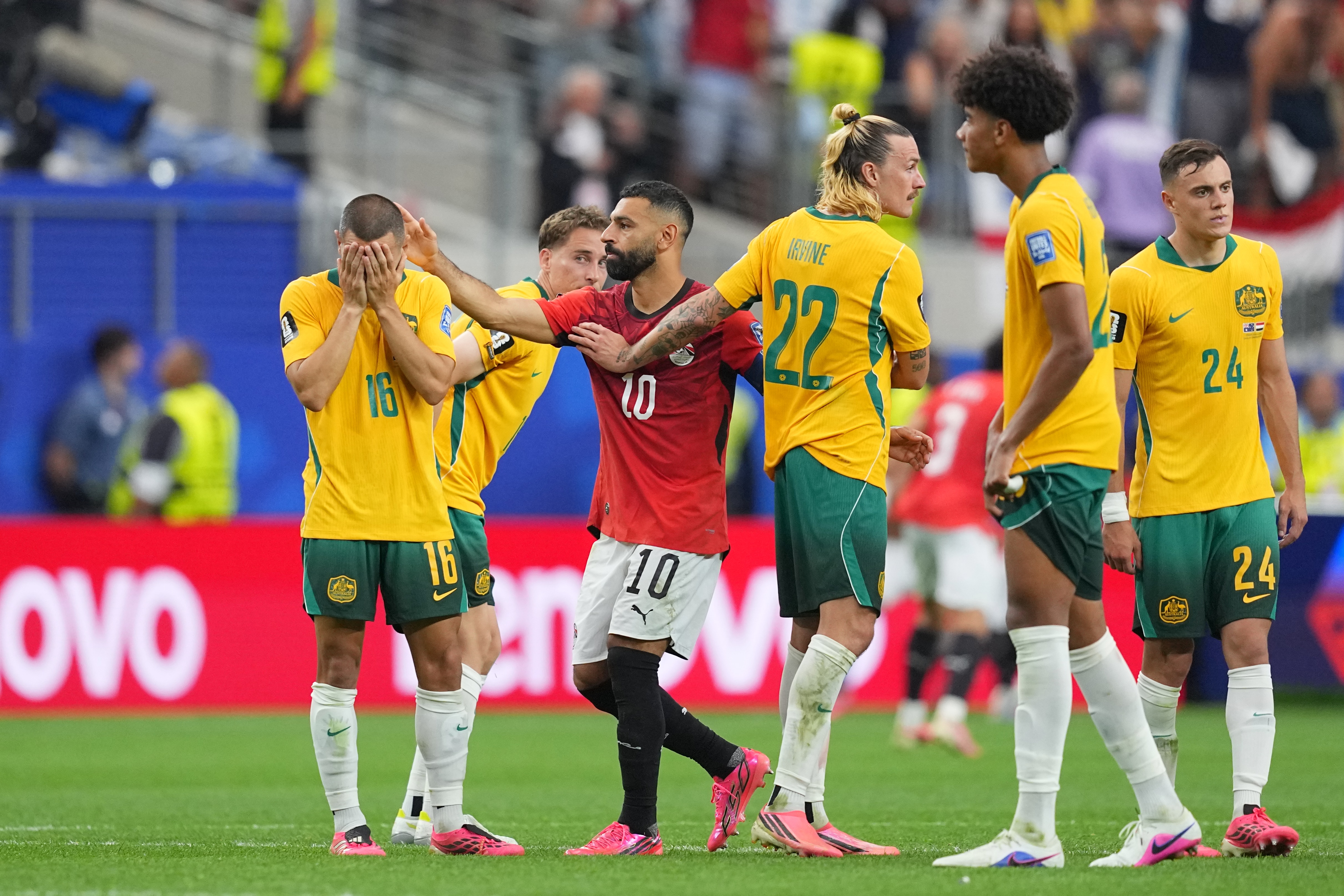 Mo Salah pats a disappointed Aziz Behich on the head