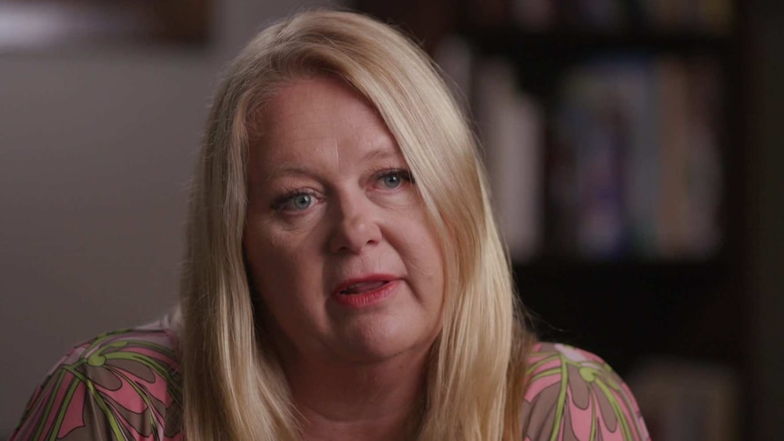 Head shot of Suzi Dent with blurry interior background