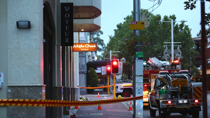 The Voyeur Bar cordoned off, with two fire trucks stopped at traffic lights