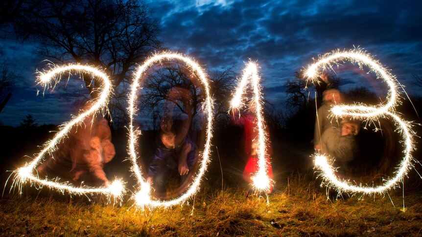 People usher in the new year by writing 2013 with sparklers.